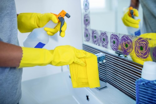 Cleaner washing a Kensington home window with care
