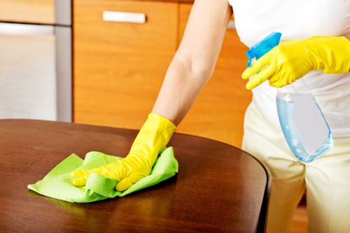 Staff member wearing protective gloves during cleaning work