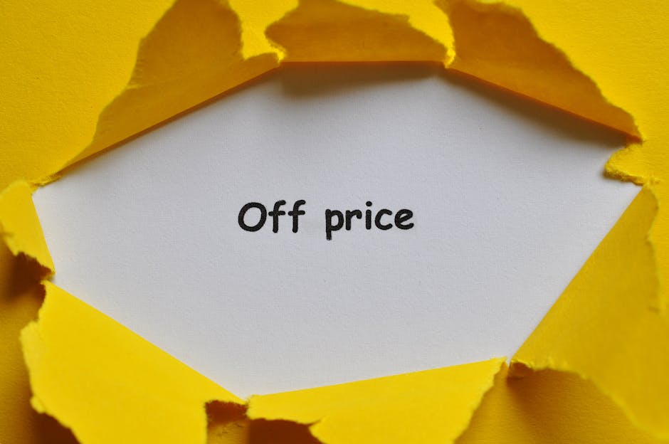 A torn yellow paper revealing a white inner surface with the handwritten words 'Off price' in black ink. The torn edges of the yellow paper are irregular and textured, creating a rough frame around th